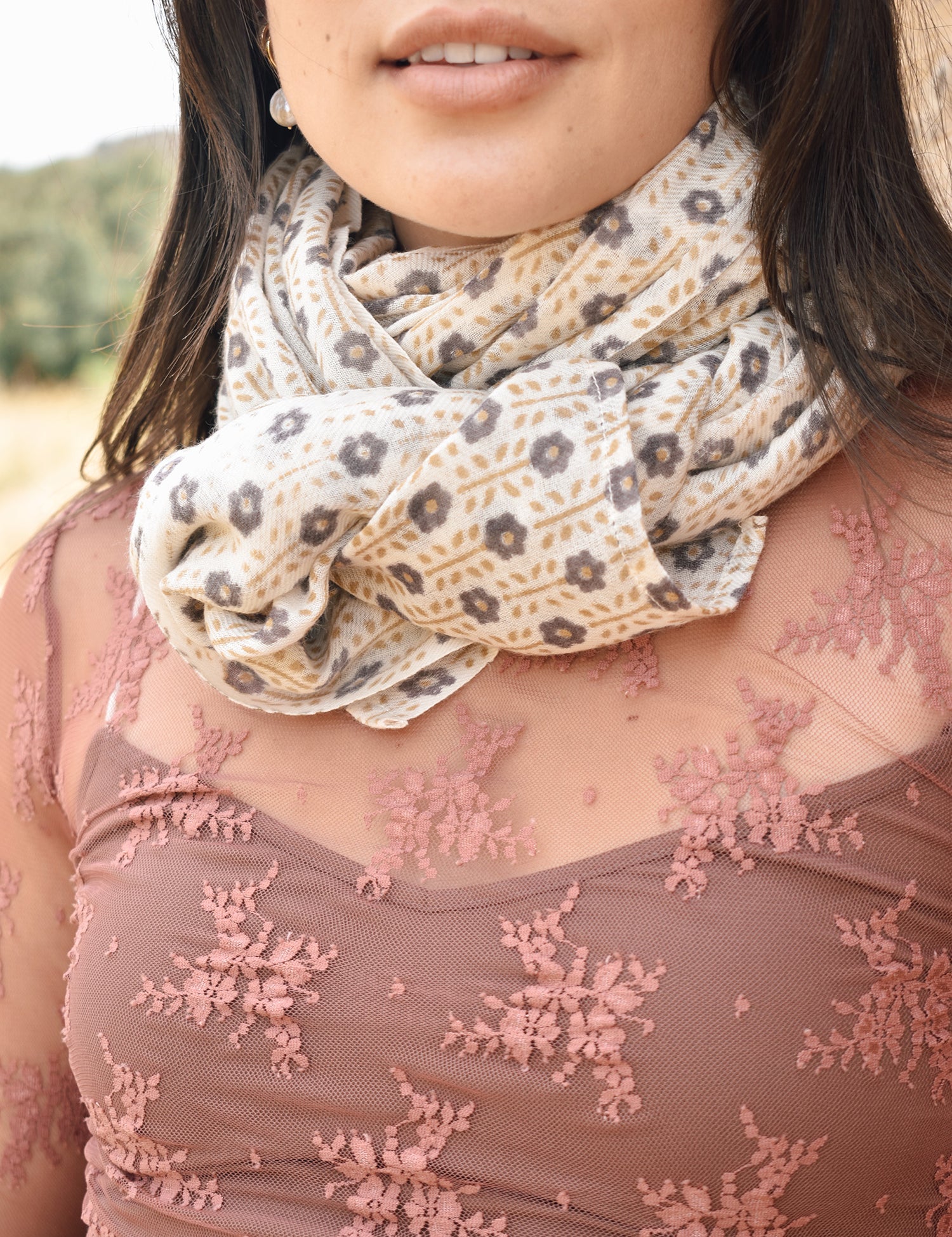 Block printed floral printed chunky wool scarf looped around the neck, worn with sheer rose long sleeve