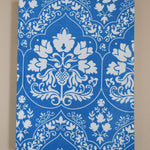 Blue and white floral patterned journal on a beige background