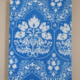 Blue and white floral patterned journal on a beige background