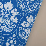 Blue and white floral-patterned journal on a beige background