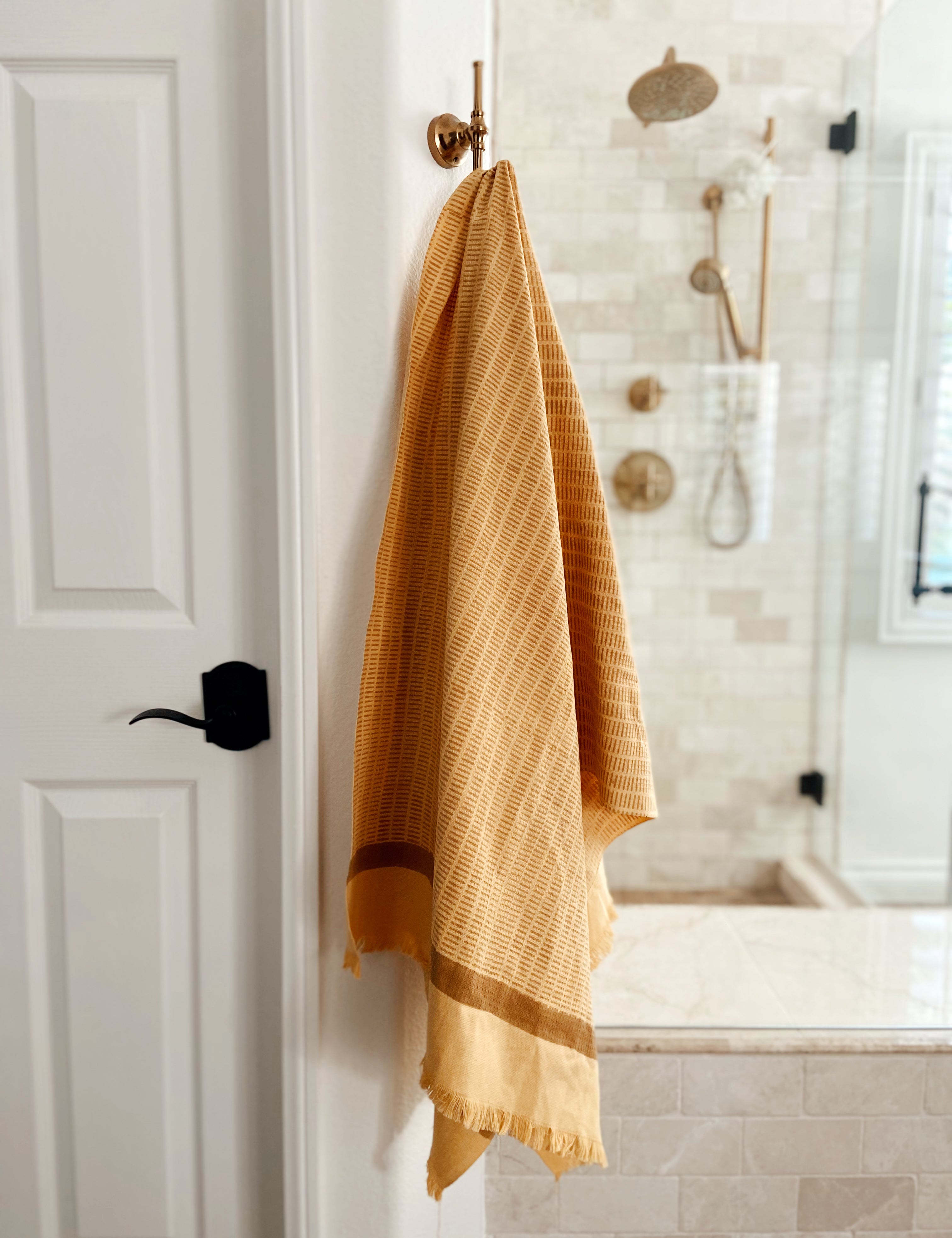 Feliz bath towel hanging on rod in the bathroom