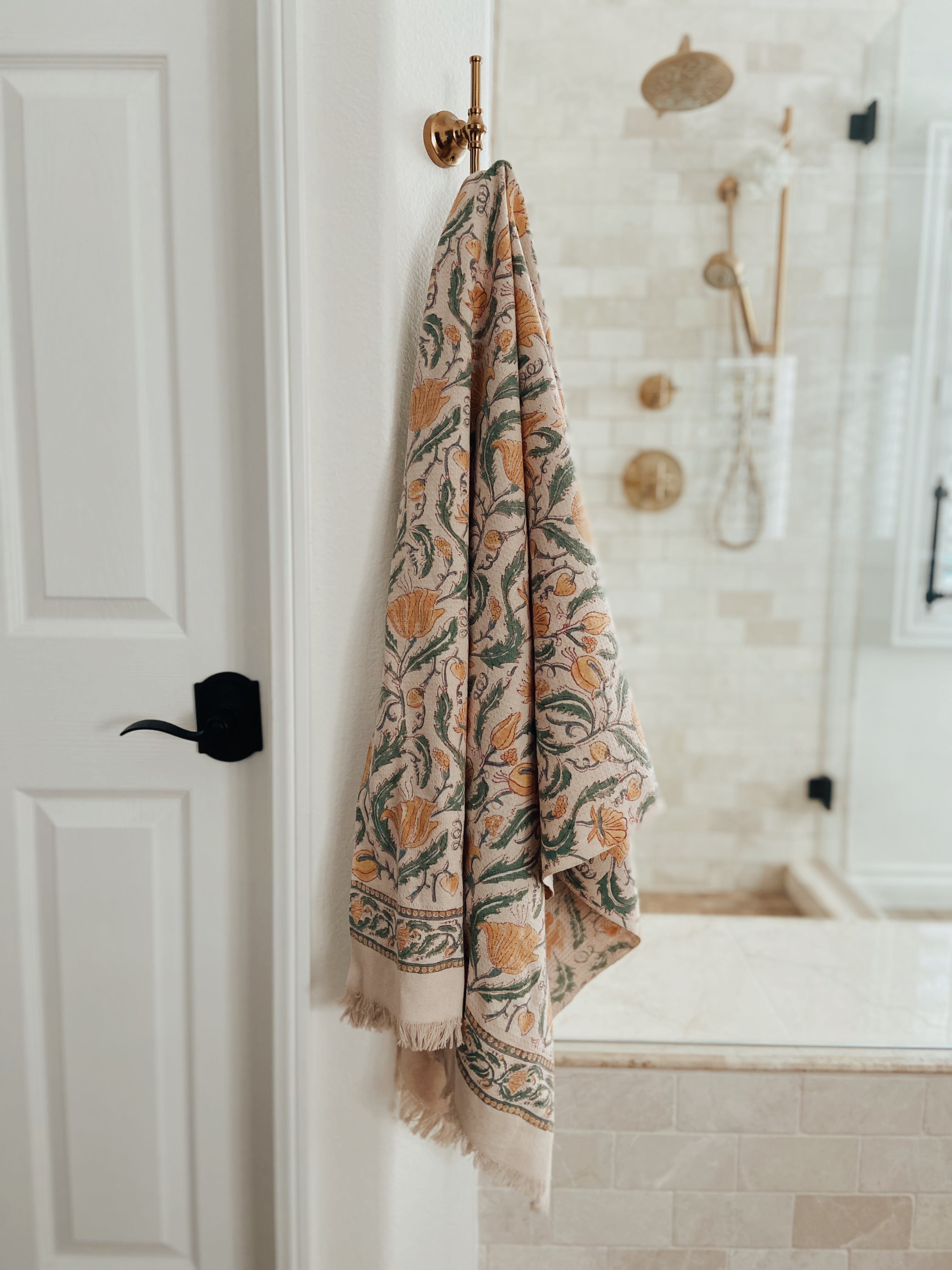 Tuscan bath towel hanging on rod in the bathroom