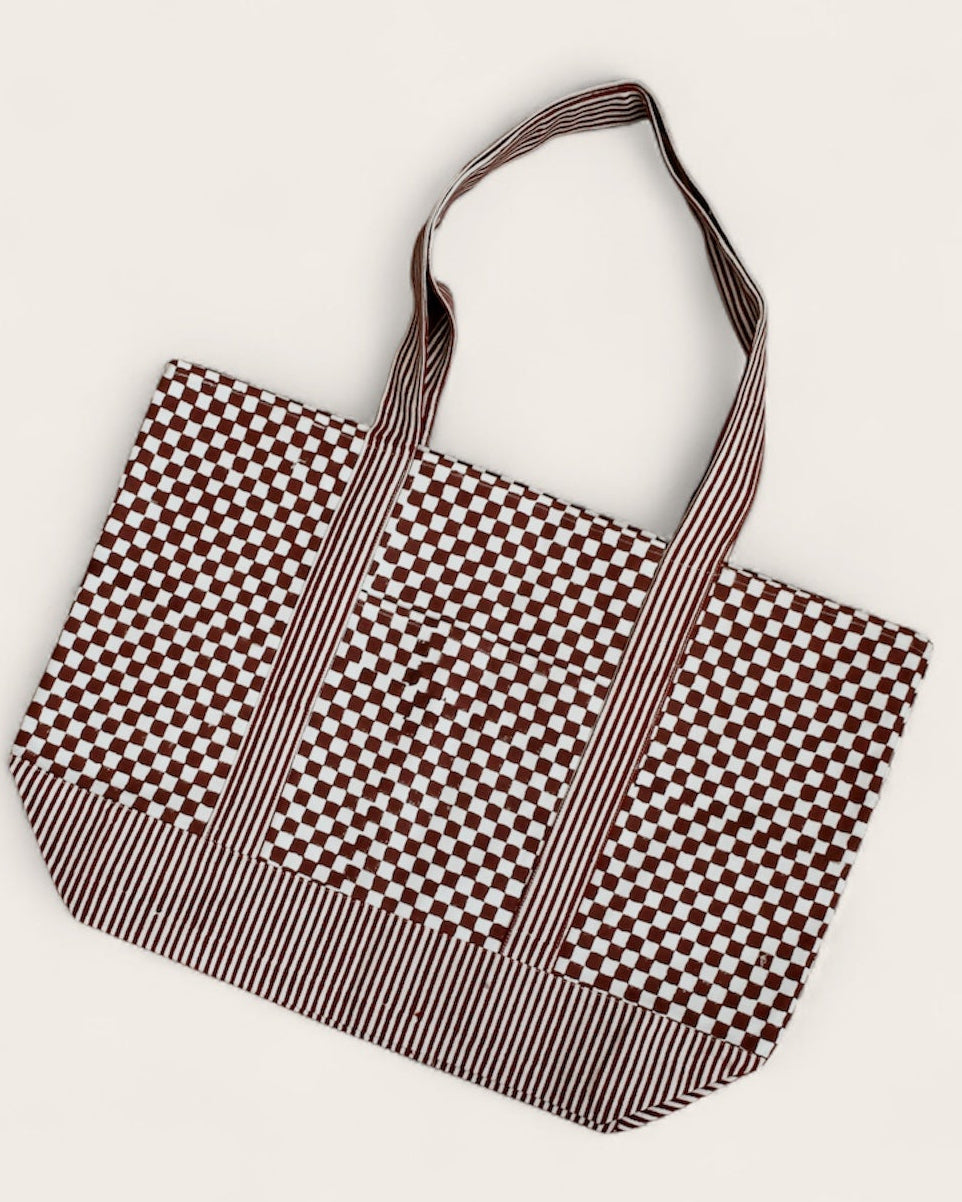 Checkered and striped tote bag laid flat 