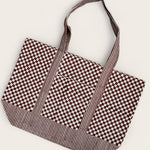 Checkered and striped tote bag laid flat 