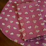 Purple floral printed placemats with matching table napkin on a wooden table