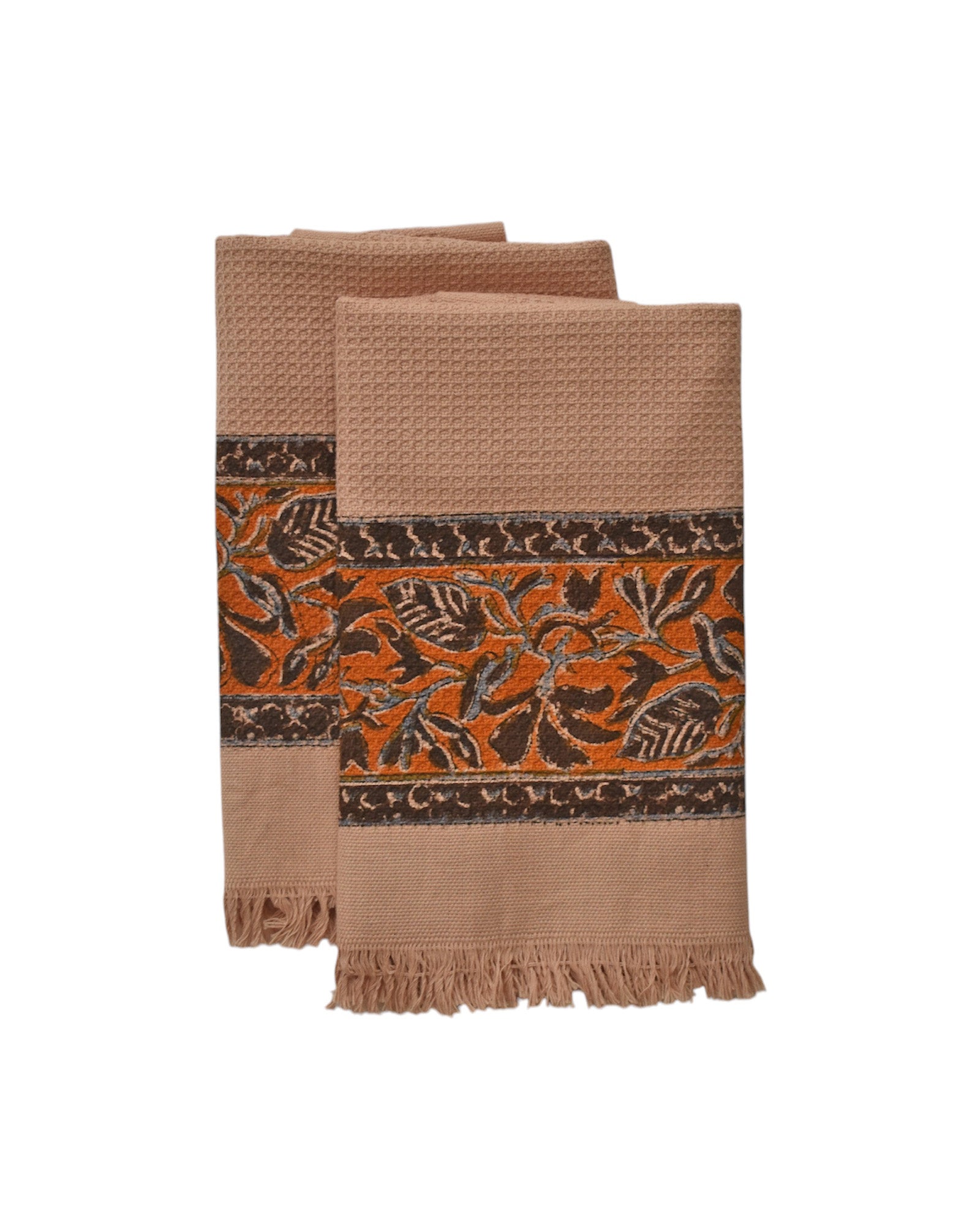 Block printed Cocoa khadi hand towels, folded and laid flat. Towels have a floral border print.