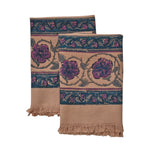 Block printed Lilac Khadi hand towels folded and laid flat. Towels have a large floral border print. 