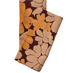 Block printed Flora table napkins, folded and laid flat. Napkins have a large, all over floral print. 
