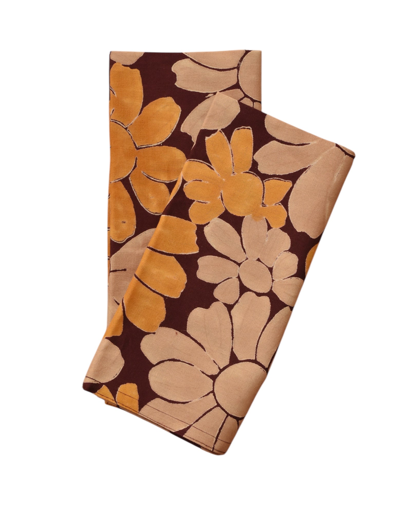 Block printed Flora table napkins, folded and laid flat. Napkins have a large, all over floral print. 