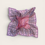 Pink and purple patterned bandana scarf on a light beige background