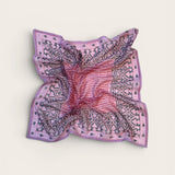 Pink and purple patterned bandana scarf on a light beige background