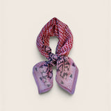 Multicolored purple and pink patterned scarf on a light beige background