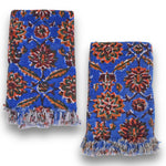 Two Adria block printed hand towels folded and placed next to each other on a white background