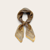A square cotton scarf tied in a knot, featuring a gray and blue abstract pattern with fine blue lines, displayed on a light beige background.