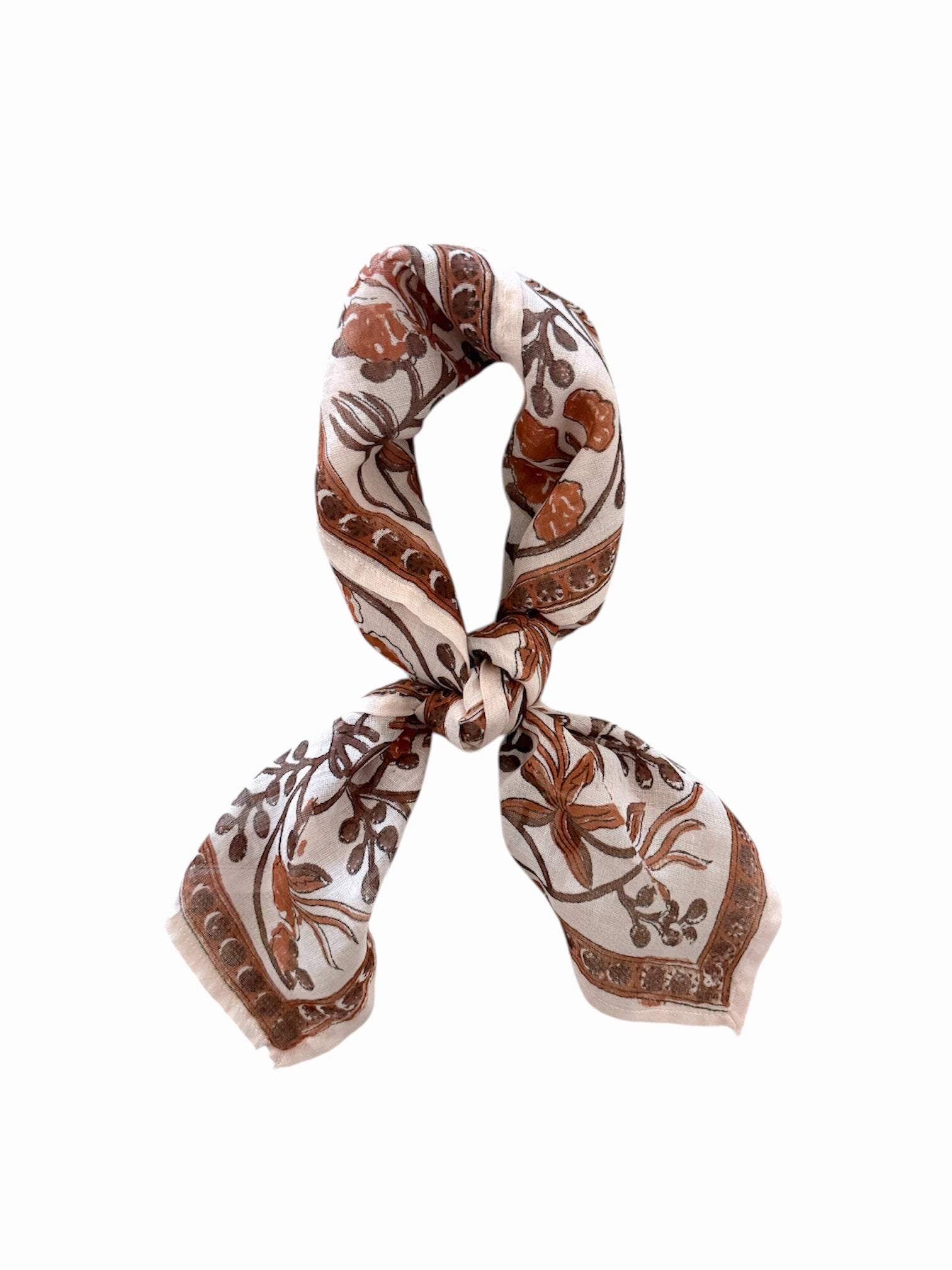 Patterned scarf with brown and beige floral design tied on a white background