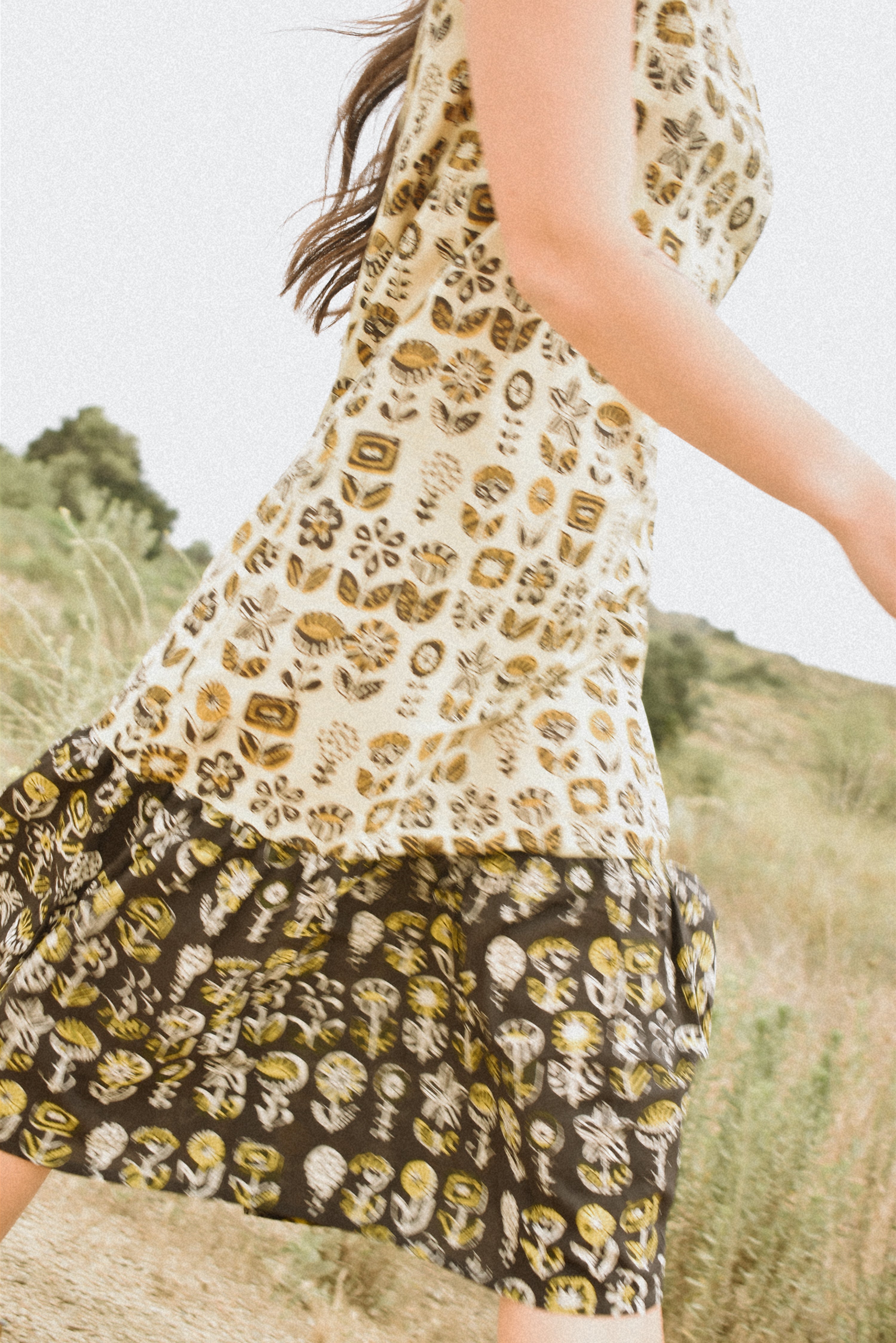 Woman wearing floral block printed sleeveless ruffle dress