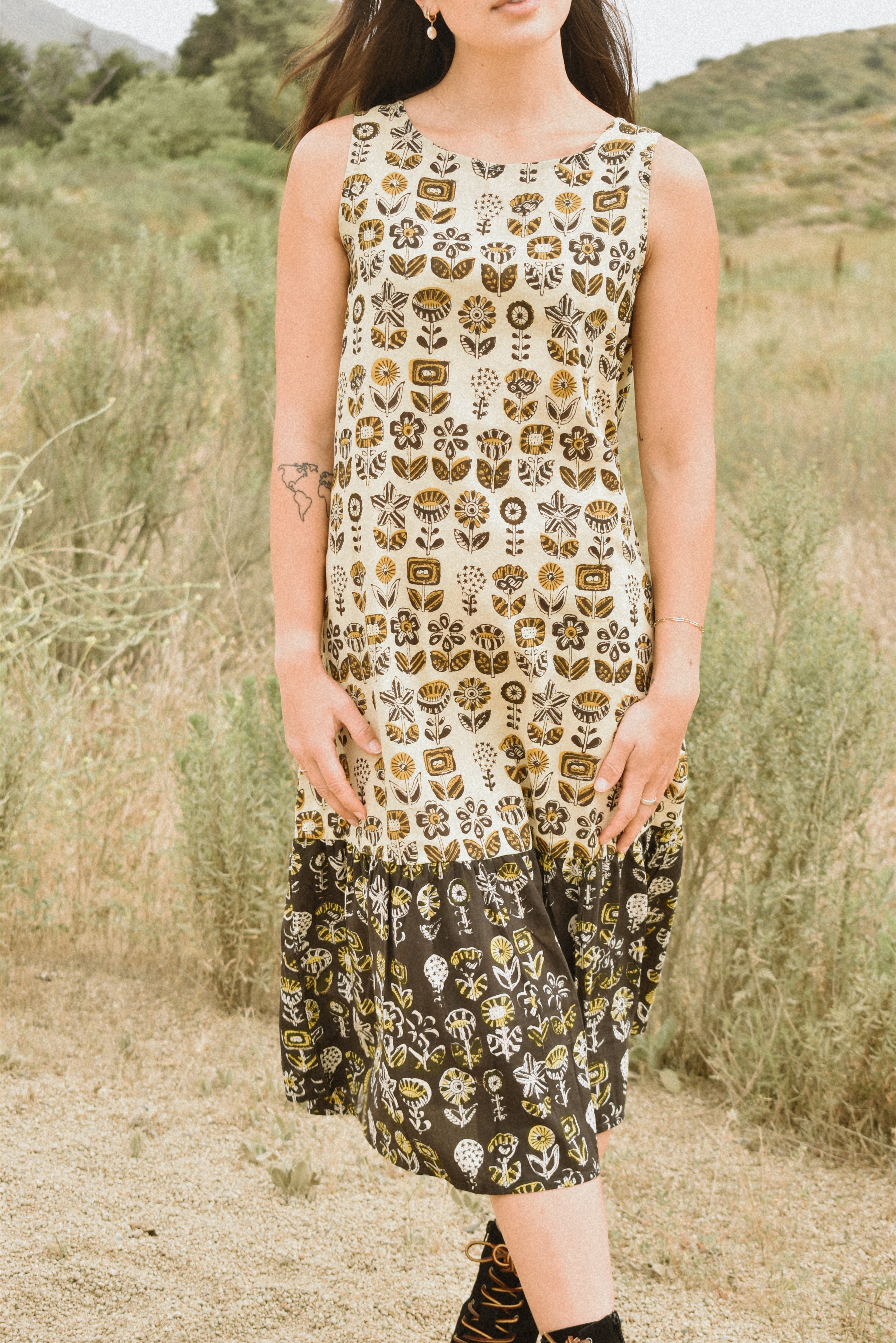 Woman wearing floral block printed sleeveless ruffle dress