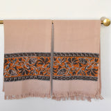 Block printed Cocoa khadi hand towels, hanging on a golden rod. Towels have a floral border print.