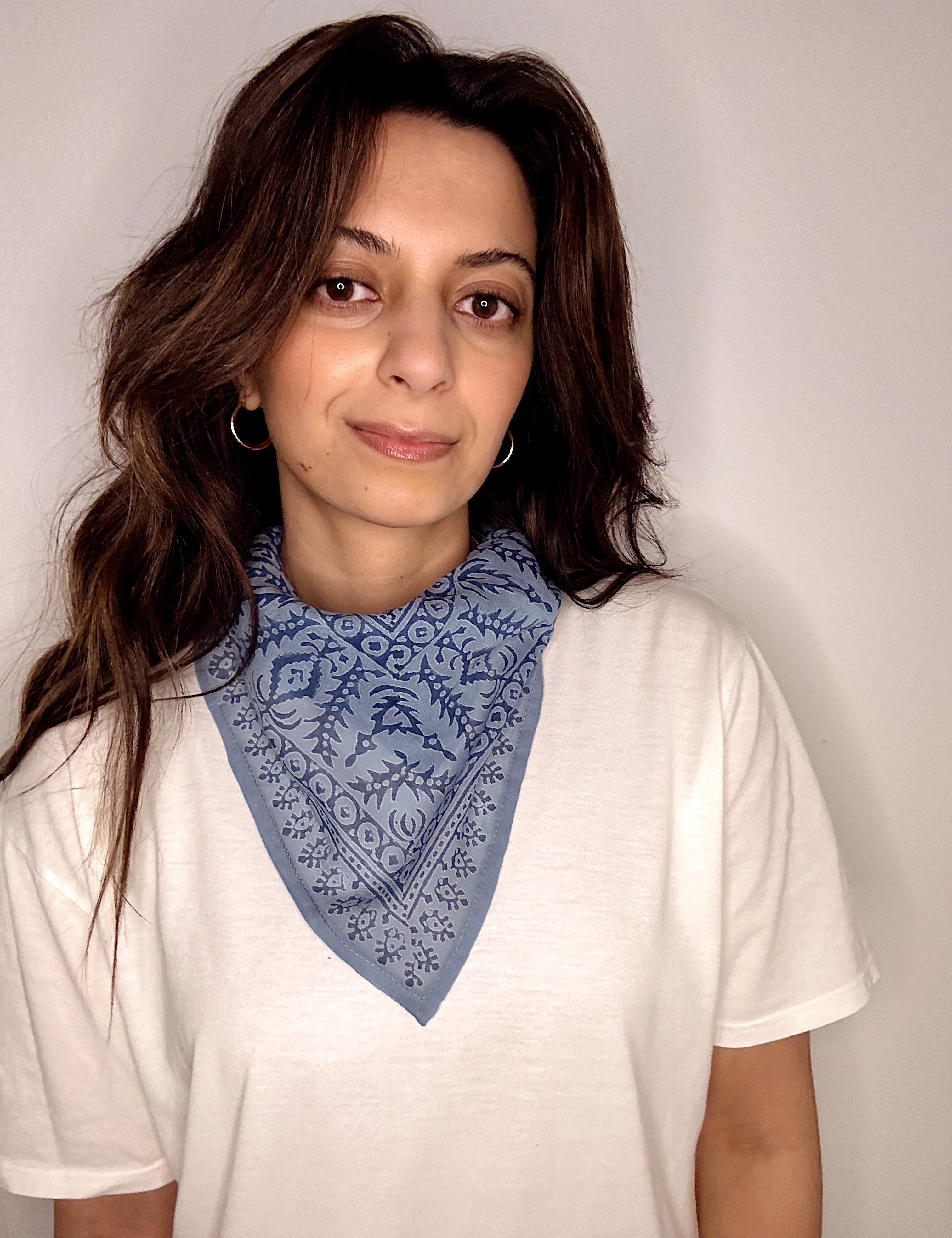 Woman wearing block printed Angelite blue bandana around the neck