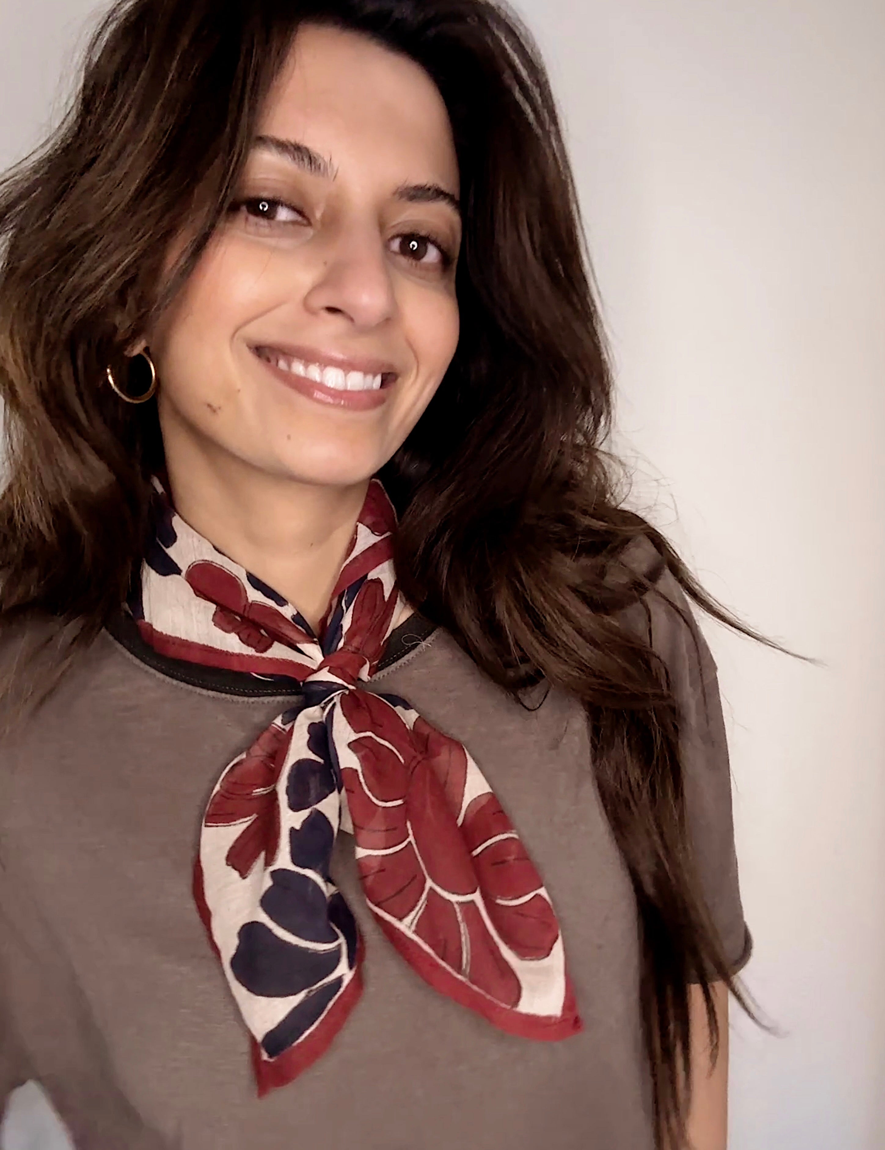 Woman wearing block printed floral Flora bandana around the neck