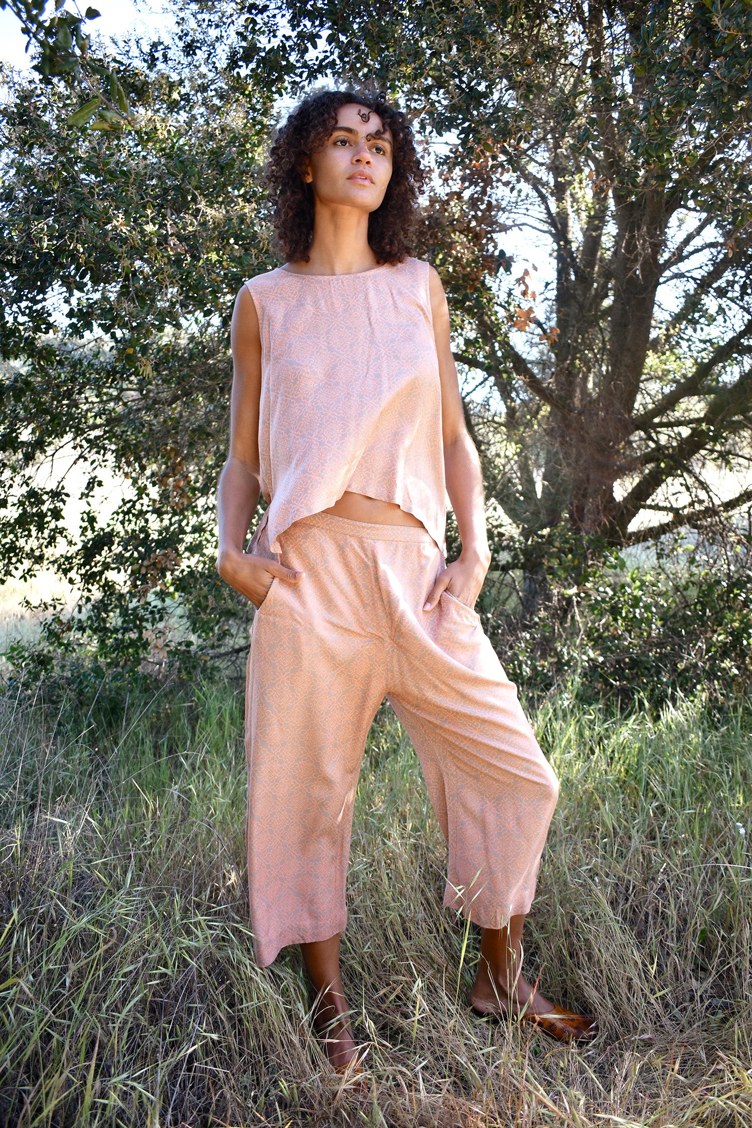 Woman wearing Alba Set, standing outside with trees in the background