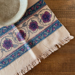 Decorative tablecloth with floral pattern on a wooden surface