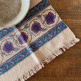 Decorative tablecloth with floral pattern on a wooden surface