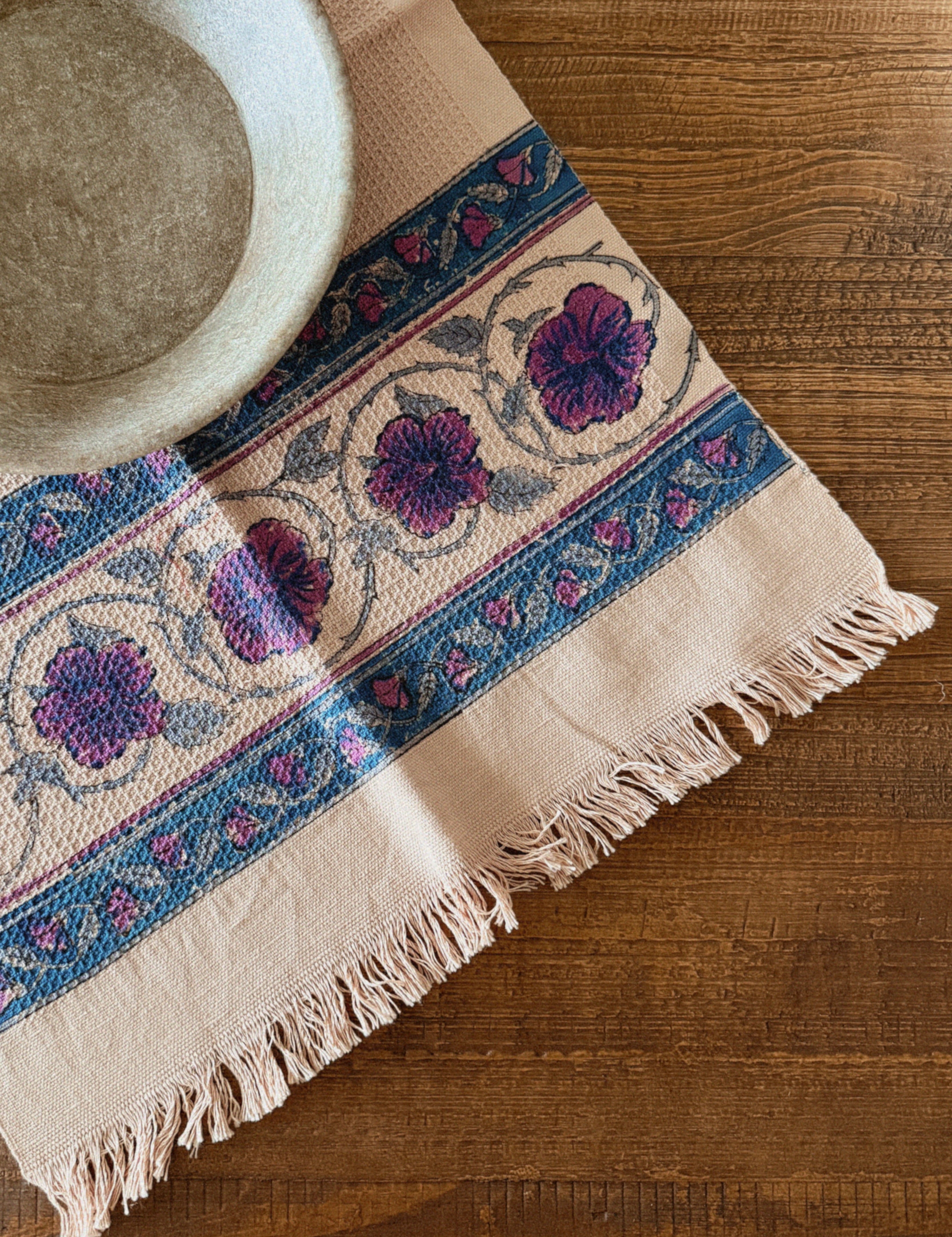 Decorative tablecloth with floral pattern on a wooden surface