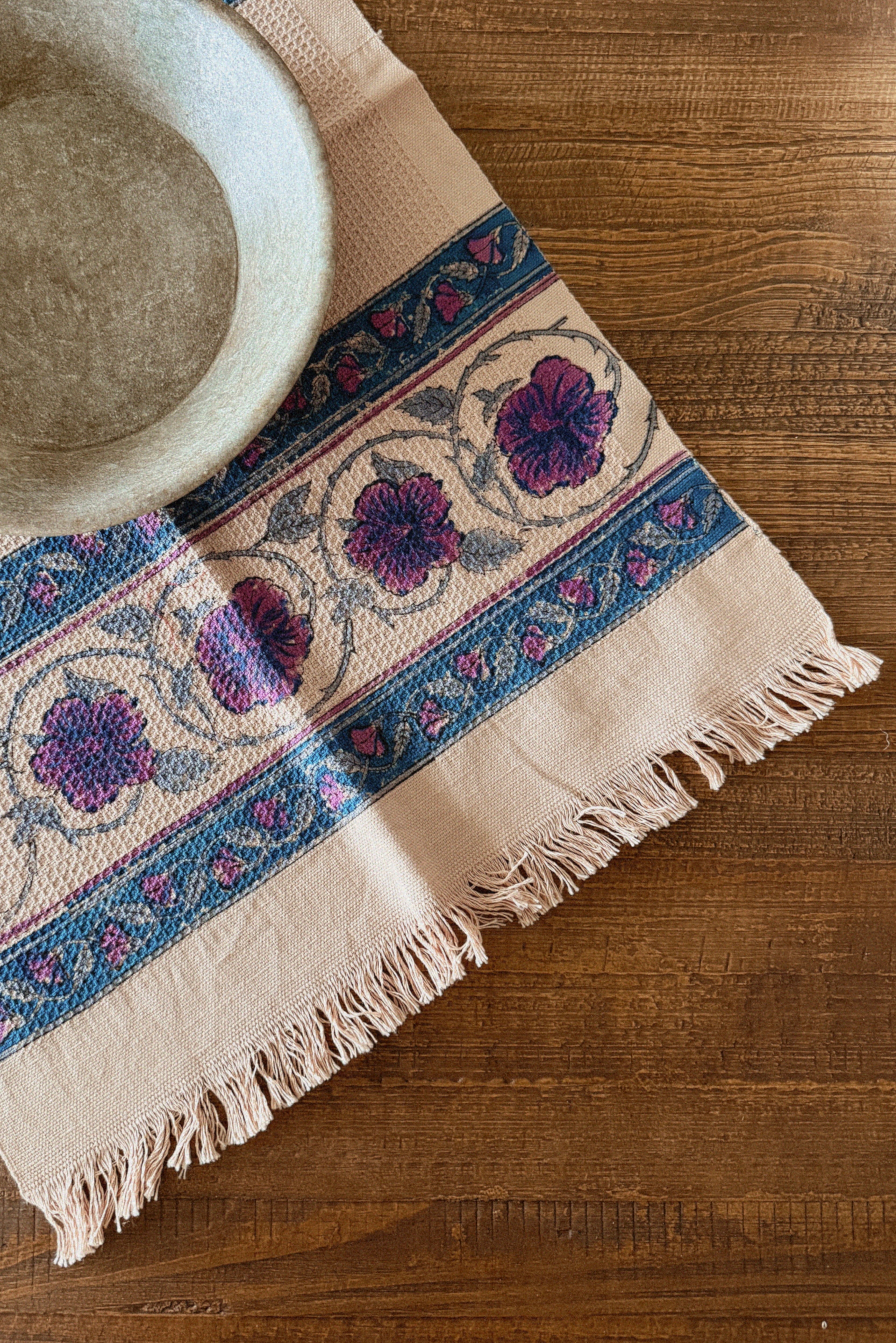 Decorative tablecloth with floral pattern on a wooden surface