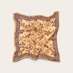 Golden Ochre Floral Bandana Scarf in lightweight cotton flat lay display with plum hand block printed flower motif and striped border against off-white background