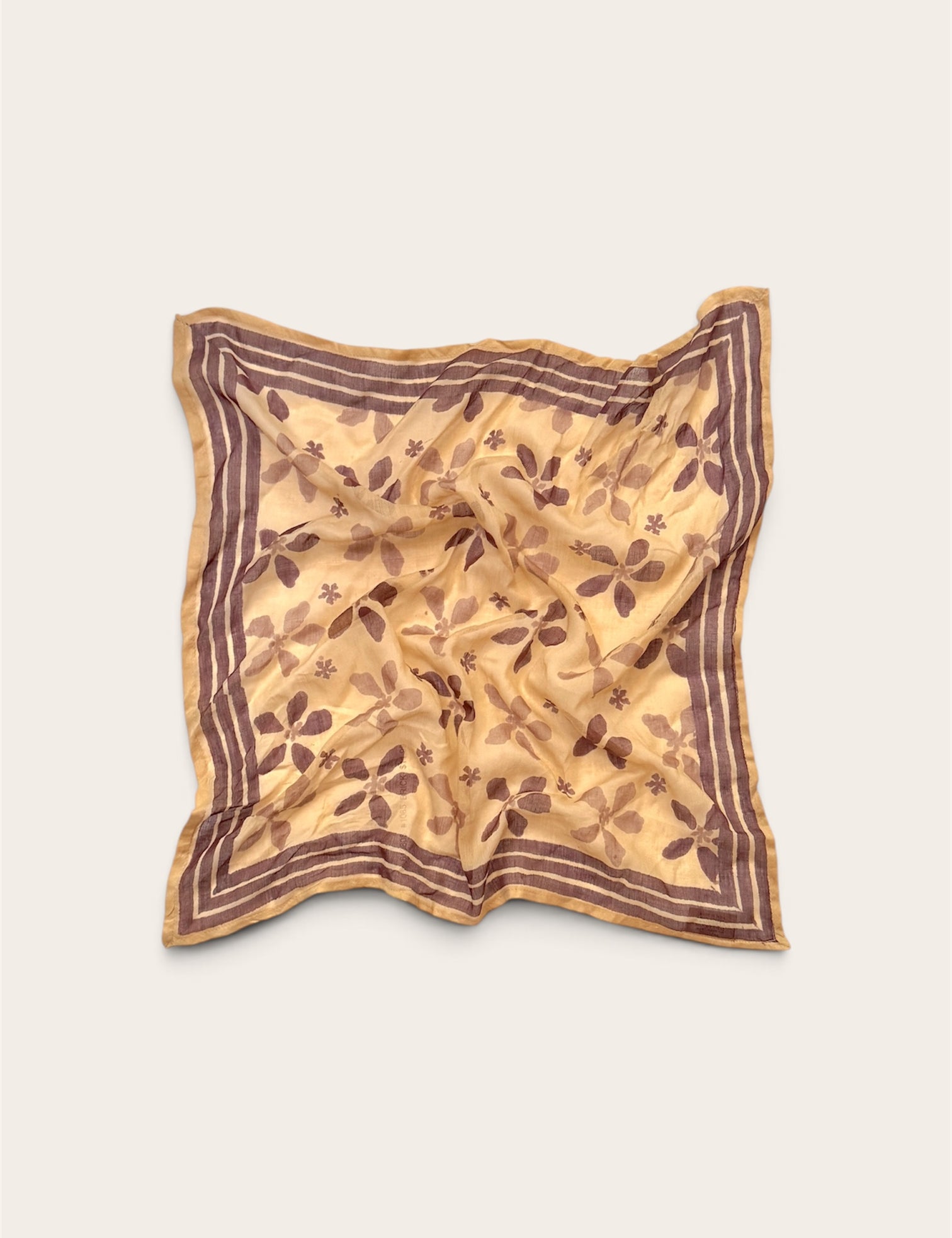 Golden Ochre Floral Bandana Scarf in lightweight cotton flat lay display with plum hand block printed flower motif and striped border against off-white background