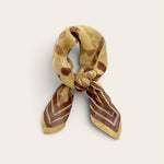 Golden Ochre Floral Bandana Scarf styled tied in a loose neck knot showing plum floral block print and bordered ends on off-white background