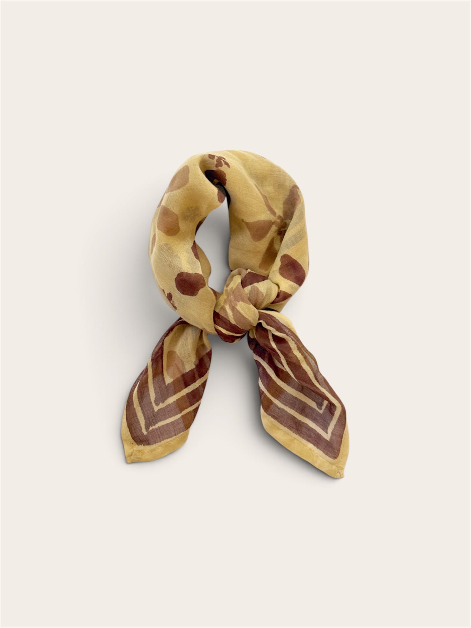 Golden Ochre Floral Bandana Scarf styled tied in a loose neck knot showing plum floral block print and bordered ends on off-white background