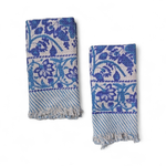 Two blue floral patterned towels on a white background