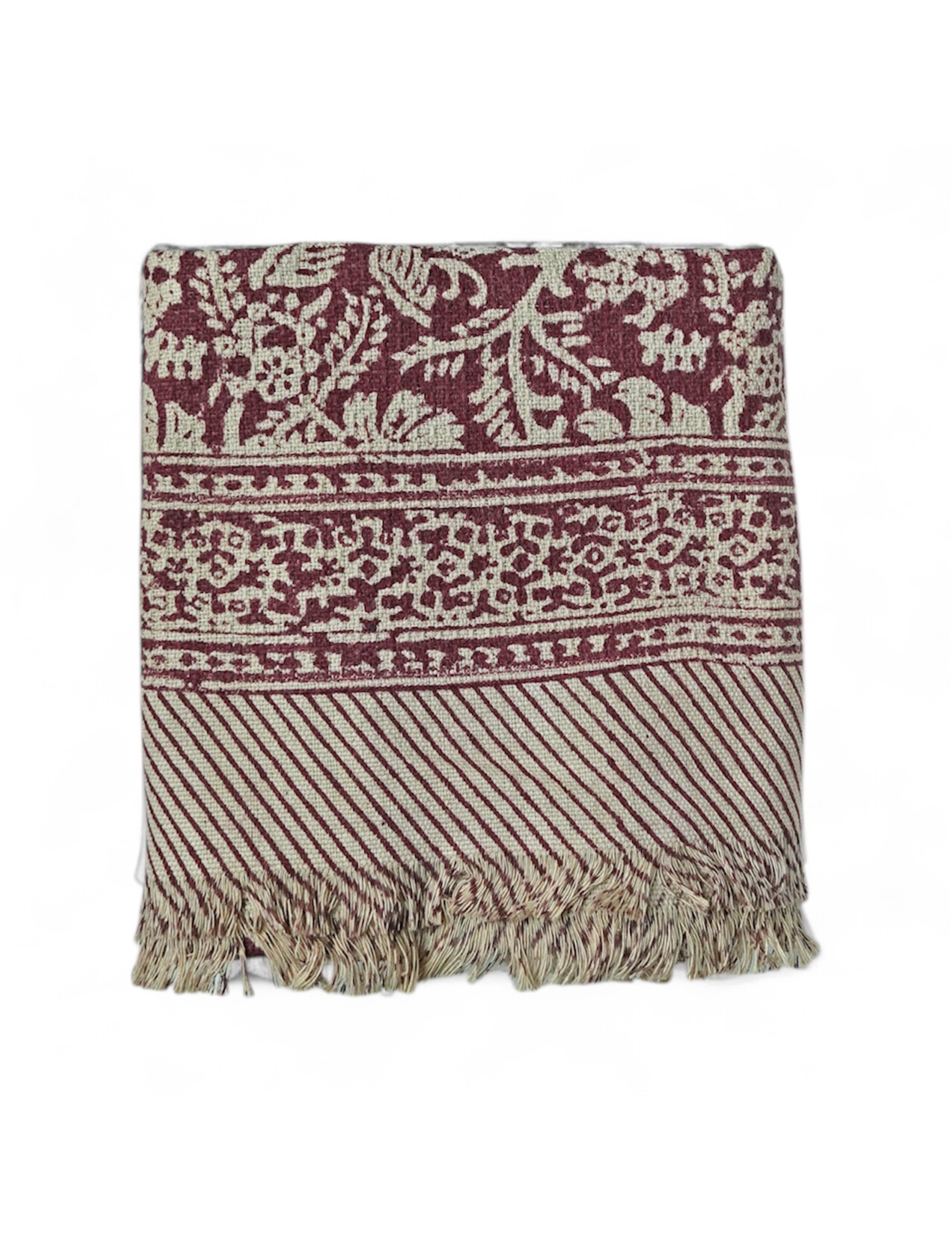 Red floral printed bath towels with intricate pattern and fringes on a white background