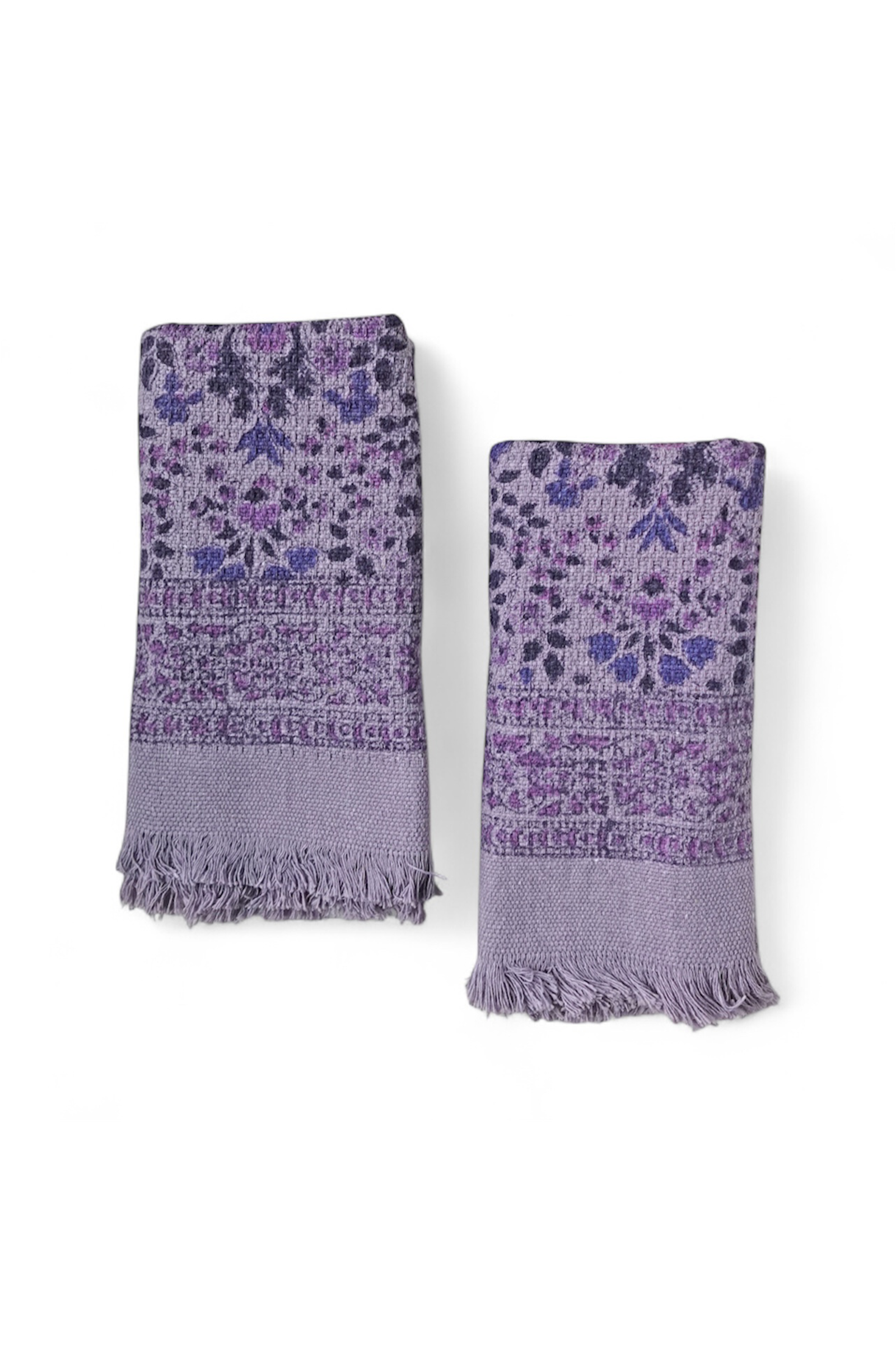 Two purple floral patterned hand towels on a white background