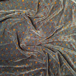 Gif showing floral printed pillow coming into shot, rotating and moving out of shot. Blanket in background flip flops between two different floral prints. 