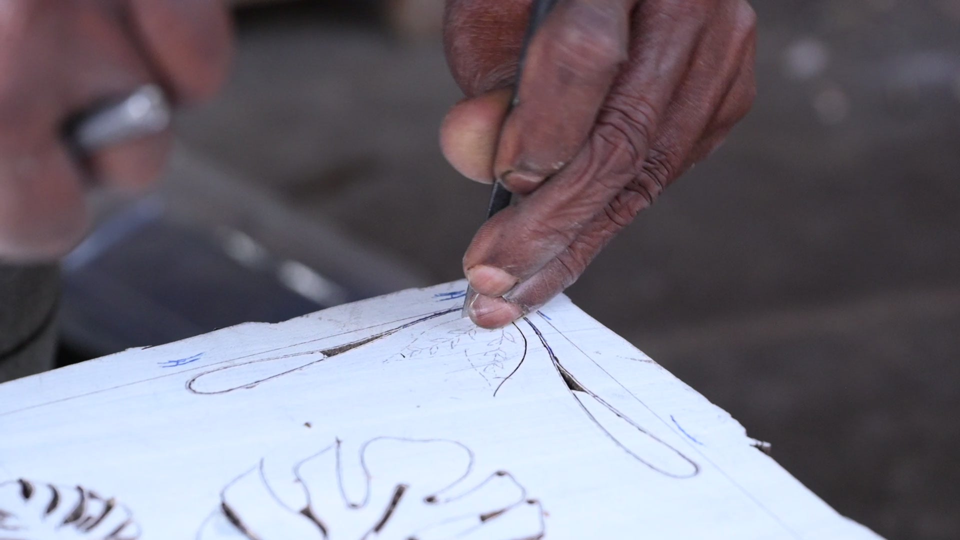 Hand carving the Monstera print into a block of wood