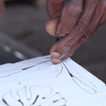 Hand carving the Monstera print into a block of wood