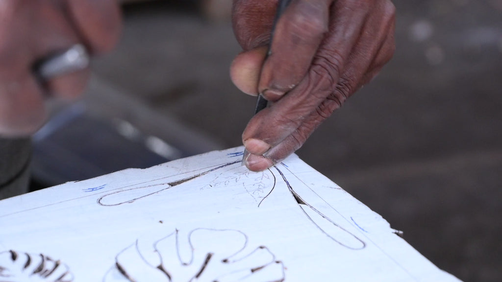 Hand carving the Monstera print into a block of wood