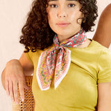 Model wearing the Zoe bandana tied around her neck, against a creamish background
