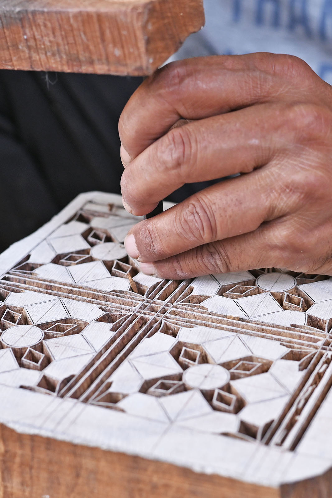 Hand carving the Alia print onto a wooden block