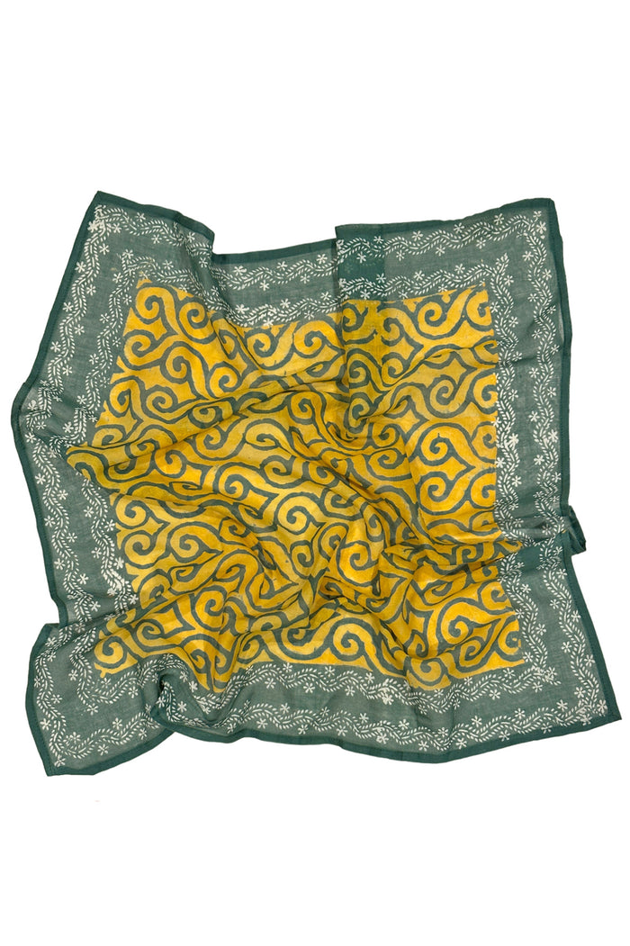 Block printed green yellow floral print cotton bandana open flat on white