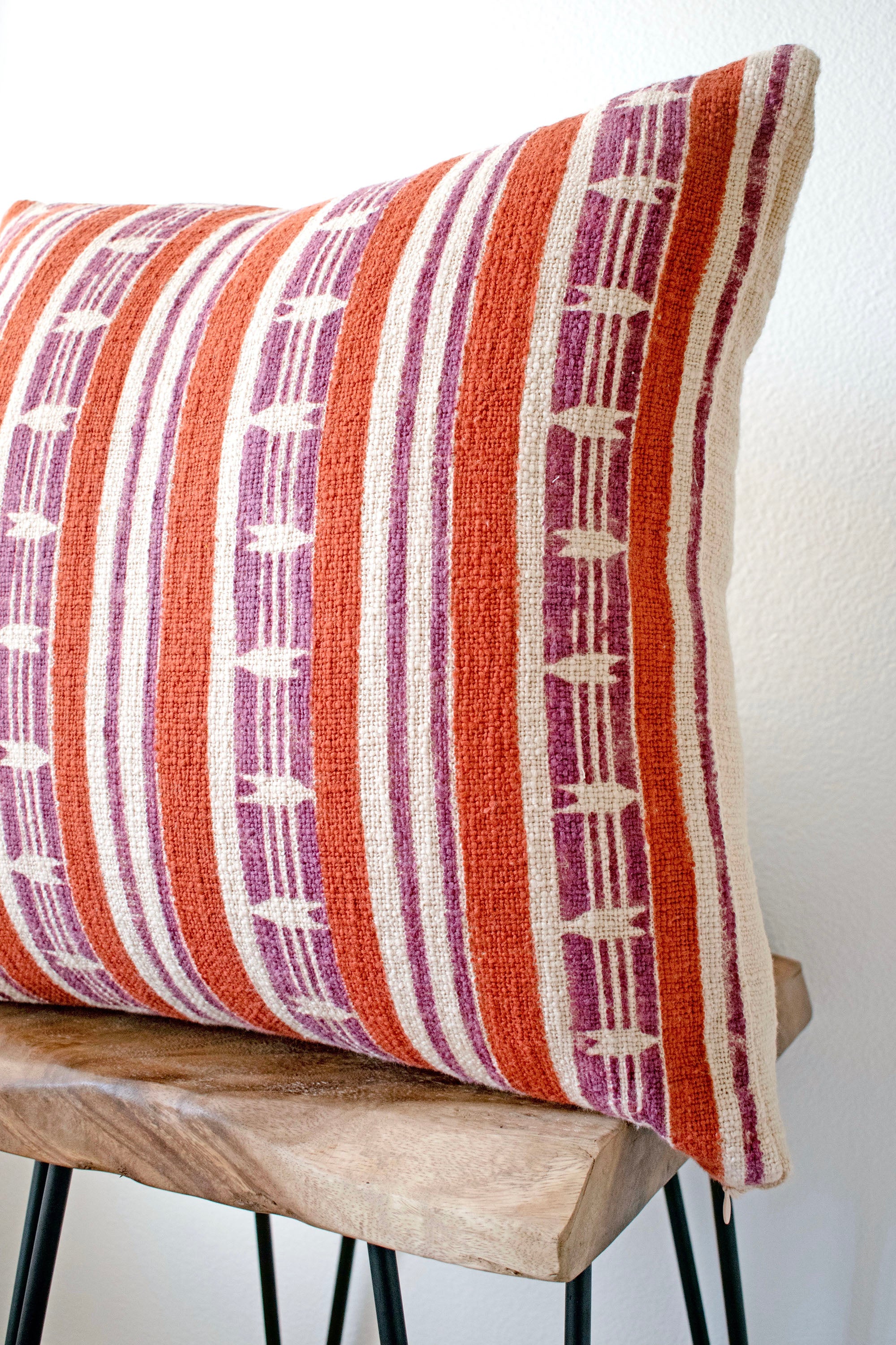 Mojave block print pillow on a stool against white, angled