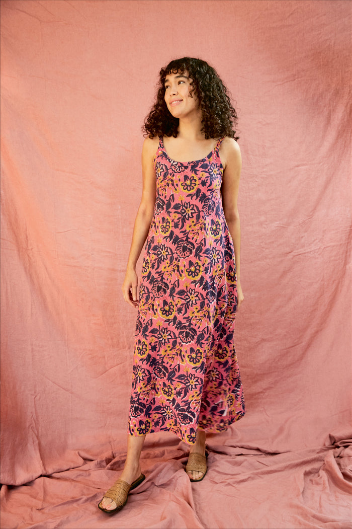Model wearing the Kate strap dress against a blush background