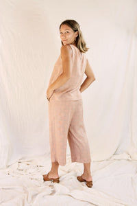 Model wearing the Alba set, against a cream color background, focus on the backside
