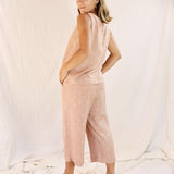 Model wearing the Alba set, against a cream color background, focus on the backside