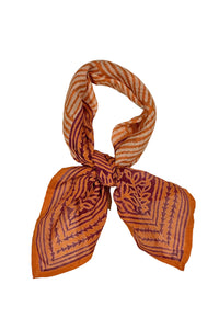 Geometric orange purple block print cotton Roshni bandana tied flat on white
