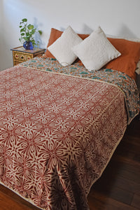 Never Leaving Home Reversible Velvet Blanket draping a full size bed, front print