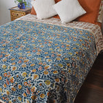Winter Wonderland Reversible Velvet Blanket draping a full size bed, back print